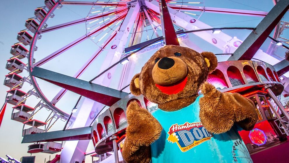  Bummel the Bear, the DOM mascot, standing in front of the great Ferris wheel.