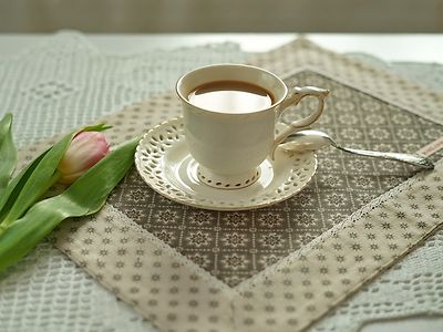  Old-fashioned coffee cup and flowers on table