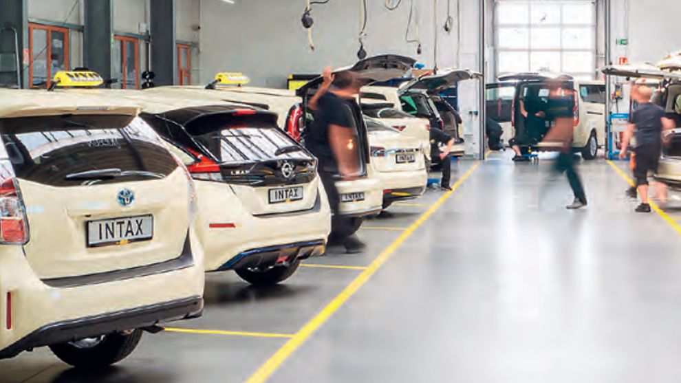  A factory hall with several electric taxis being charged.
