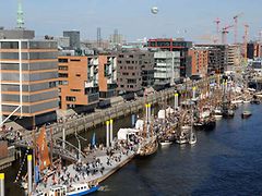  Harbour with piers and traditional sail ships in front of modern architekture and skyline