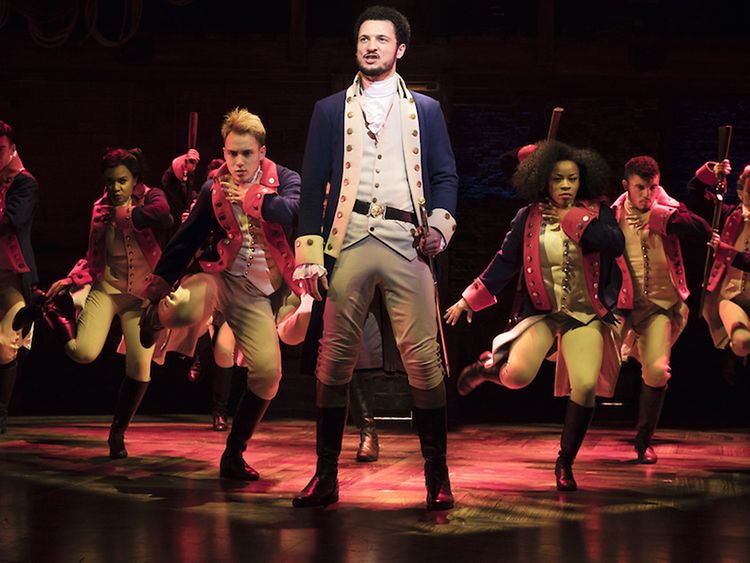  Scene from Hamilton: Alexander Hamilton and other cast members stand guard in uniform.