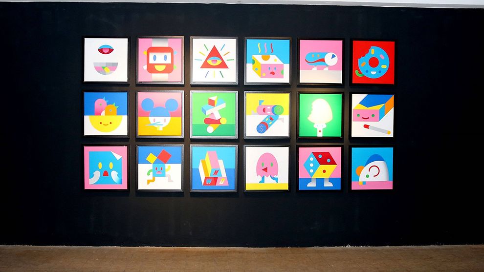 Several colourful paintings organised symmetrically before a black backdrop