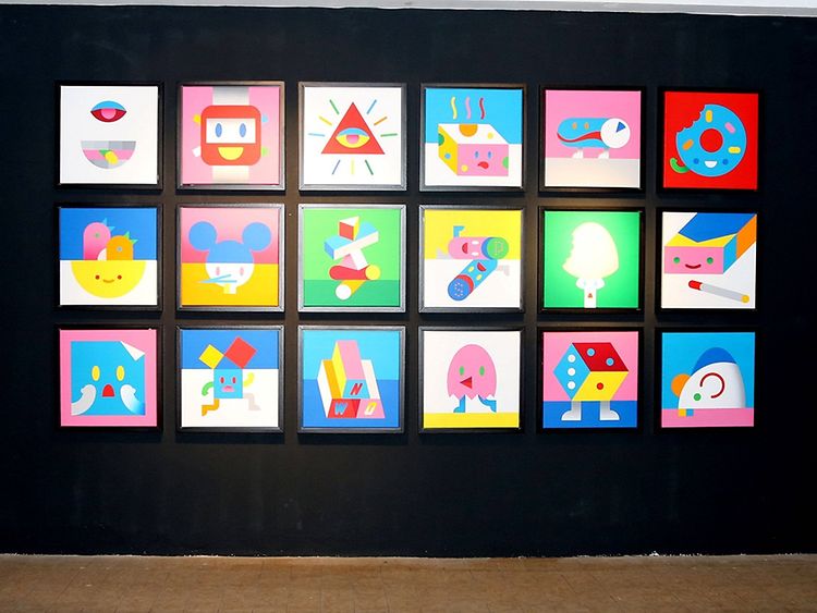  Several colourful paintings organised symmetrically before a black backdrop