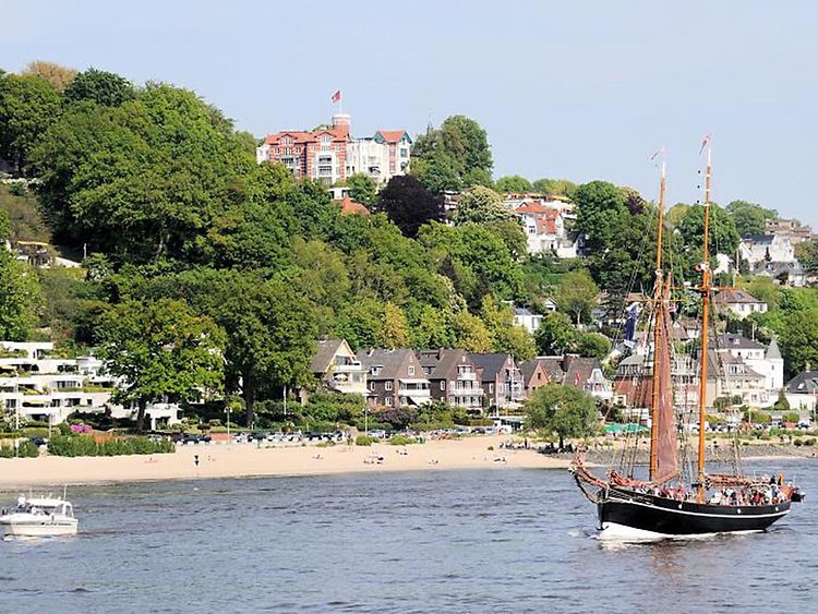  Scenic views of the Elbstrand beach near Blankenese with a sailing boat in foreground